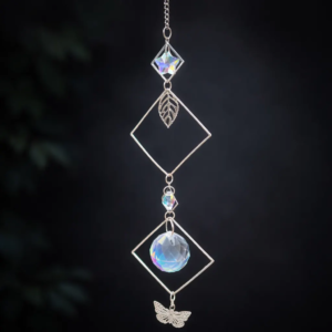 Handmade crystal prism suncatcher with diamond metal frames, leaf charm, and faceted crystal on elegant dark background.