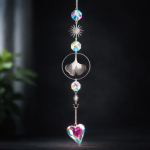 Handmade crystal ginkgo leaf suncatcher with rainbow prism heart on elegant dark background