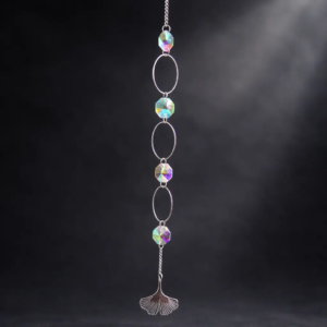 Triple hoop crystal prism suncatcher with iridescent beads and silver hoops on dark elegant background.
